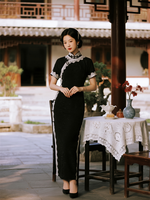 Saved person reference in a black dress standing in a courtyard.