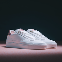 Saved input preview of white sneakers on a pink surface against a dark background.